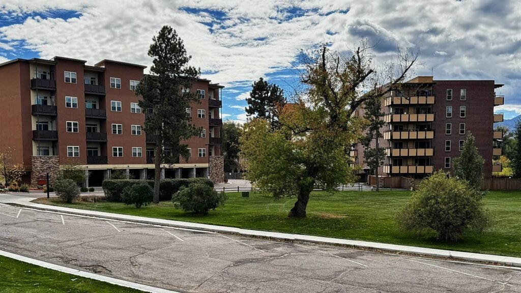 Park Manor Apartments Buildings 16 and 17 on Valley Place surrounded by mature trees and lawn in Colorado Springs